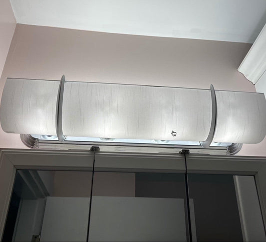 Shantung white fabric shade covering a beveled edge hollywood strip light