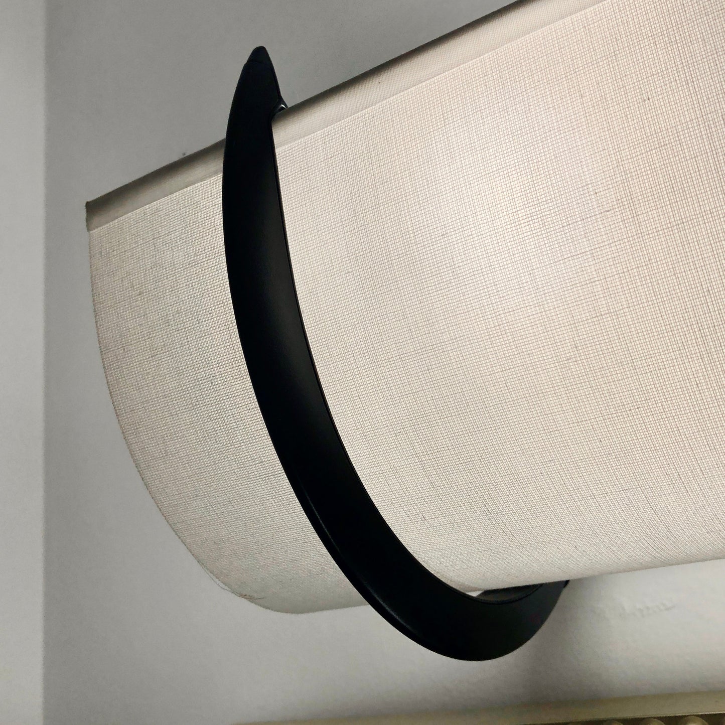 Smooth white EzLightWraps shade with a wrought iron bracket
