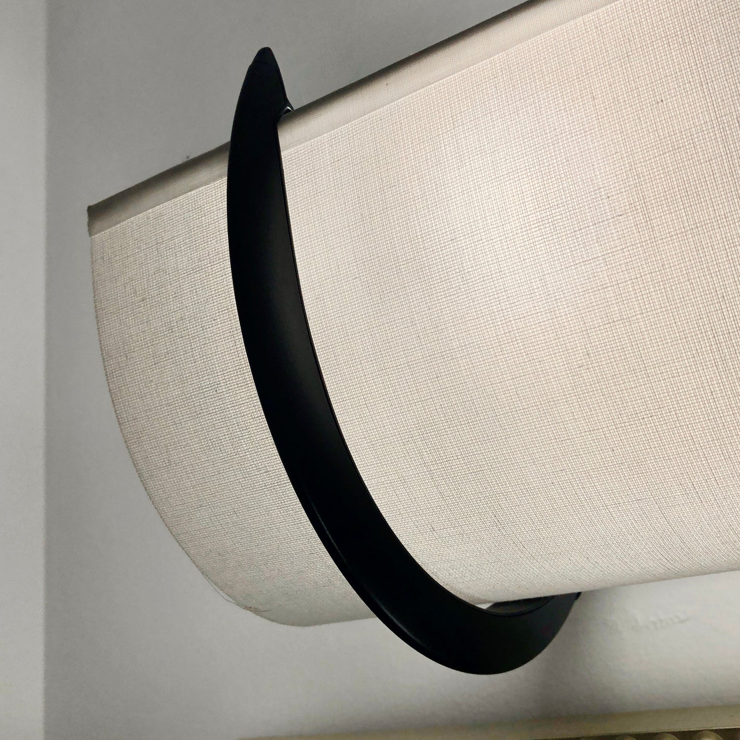 Smooth white EzLightWraps shade with a wrought iron bracket