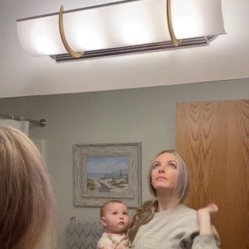 woman holding baby installs her own shade