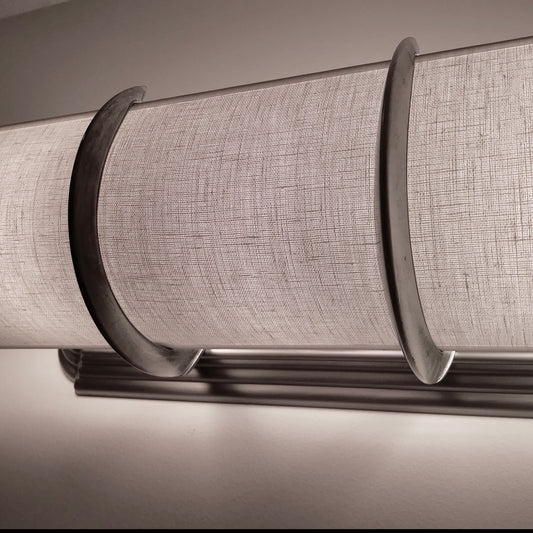This is a white linen shade with 2 silver brackets over a beveled edge light. Usually on a beveled edge we can hide the bulbs but not the bottom of the fixture.