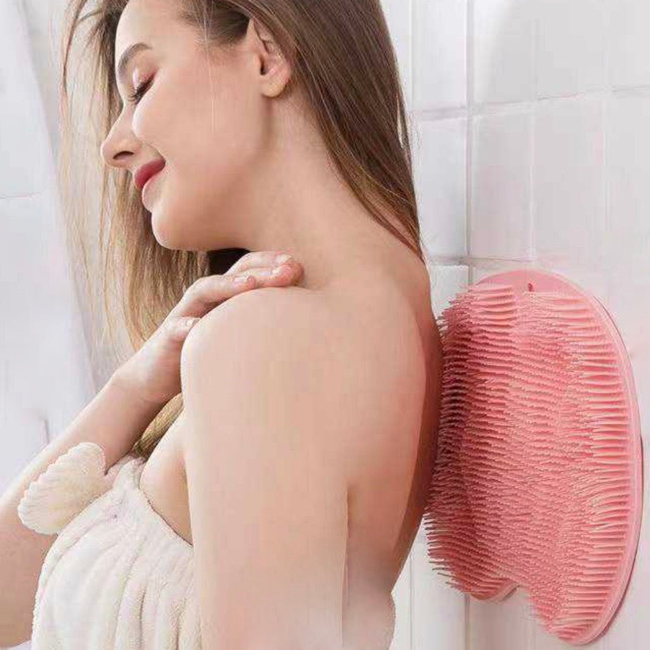 Pink bath scrubber shown on shower wall with woman 